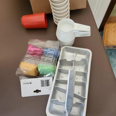 Kitchen plastic food containers including some Tupperware, silverware and other accessories