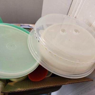 Kitchen plastic food containers including some Tupperware, silverware and other accessories
