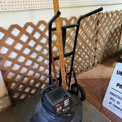 Garage lot,shop vacuum, dolli, yardsticks lattice 4 by 8 sheet