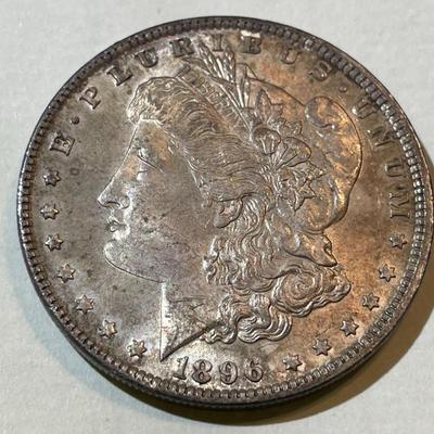 1896-P TONED UNCIRCULATED CONDITION MORGAN SILVER DOLLAR AS PICTURED.