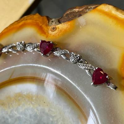 Sterling Silver .925 Dainty Heart Shaped Red Stones Bracelet 7-1/2" Long in VG Condition.