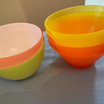 Bright color plastic tumblers and bowls with orange server