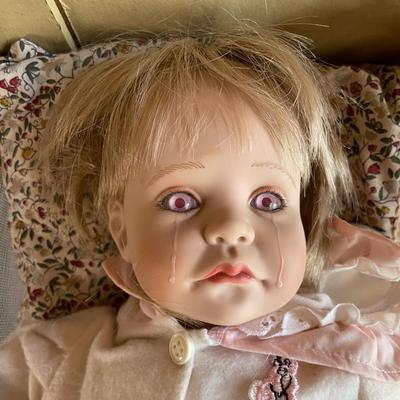 Antique Doll in a Crib
