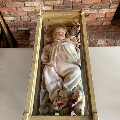 Antique Doll in a Crib