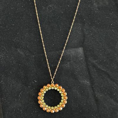 Rhinestone circle charm on silver tone necklace