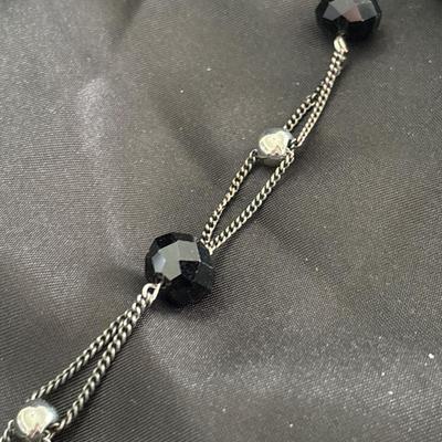 Silver tone long black and silver beaded necklace