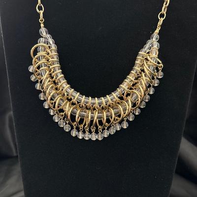 Gold toned dangling bib necklace