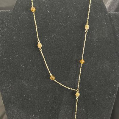 Gold tone necklace with tan beaded beads