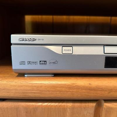 WOODEN CABINET ON CASTERS AND A SHARP DVD PLAYER W/REMOTE