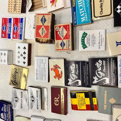 Huge bowl filled with matchbooks, ashtray, book about matches