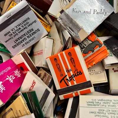 Huge bowl filled with matchbooks, ashtray, book about matches