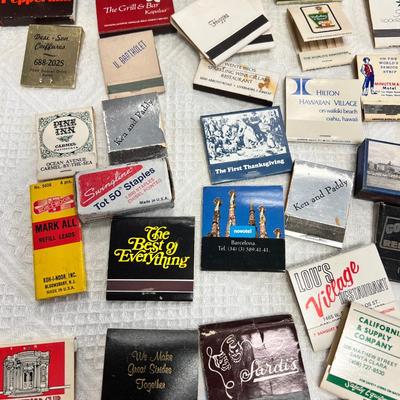 Huge bowl filled with matchbooks, ashtray, book about matches