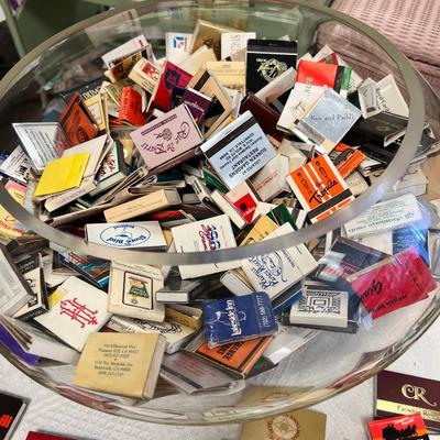 Huge bowl filled with matchbooks, ashtray, book about matches