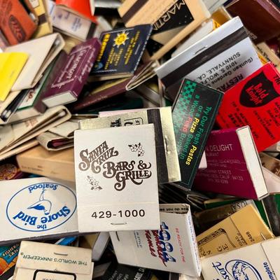 Huge bowl filled with matchbooks, ashtray, book about matches