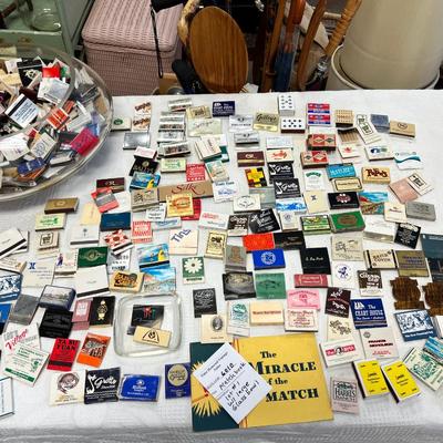 Huge bowl filled with matchbooks, ashtray, book about matches