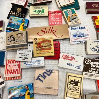 Huge bowl filled with matchbooks, ashtray, book about matches