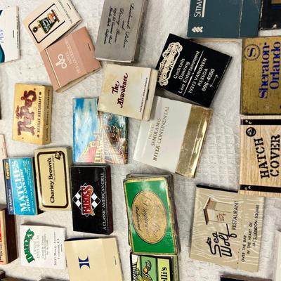 Huge bowl filled with matchbooks, ashtray, book about matches