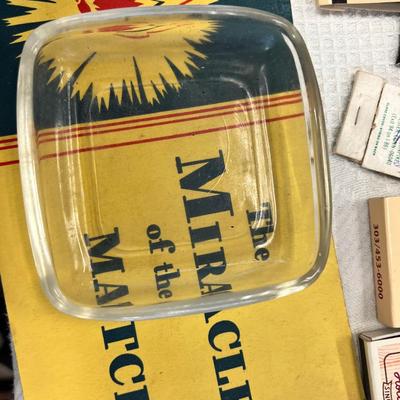 Huge bowl filled with matchbooks, ashtray, book about matches