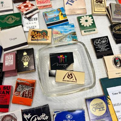 Huge bowl filled with matchbooks, ashtray, book about matches