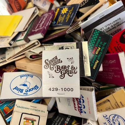 Huge bowl filled with matchbooks, ashtray, book about matches