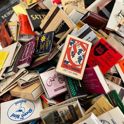 Huge bowl filled with matchbooks, ashtray, book about matches