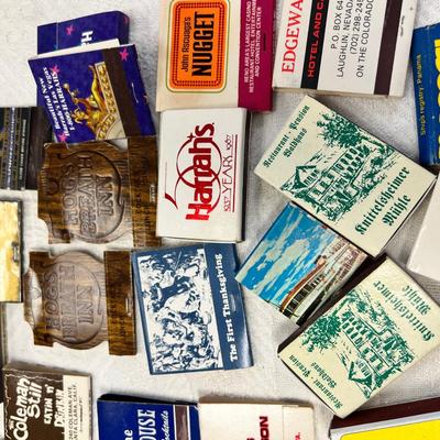 Huge bowl filled with matchbooks, ashtray, book about matches