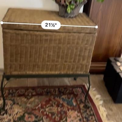 Wicker chest on stand with a rug