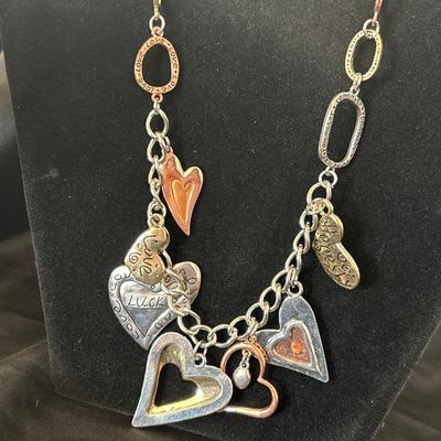 Silver, gold, and bronze toned charmed necklace