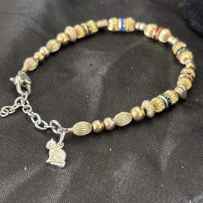 Gold tone beaded bracelet with silver tone cat charm