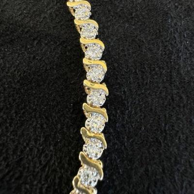 14 k Gold and diamond tennis bracelet