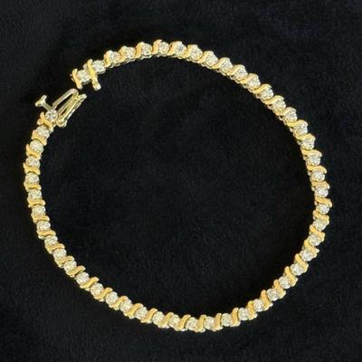 14 k Gold and diamond tennis bracelet