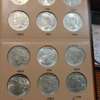 Complete peace dollar book including Rare 1921 thru 1935 reserve set