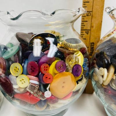 4 glass containers full of vintage buttons