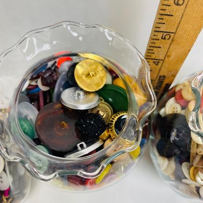 4 glass containers full of vintage buttons