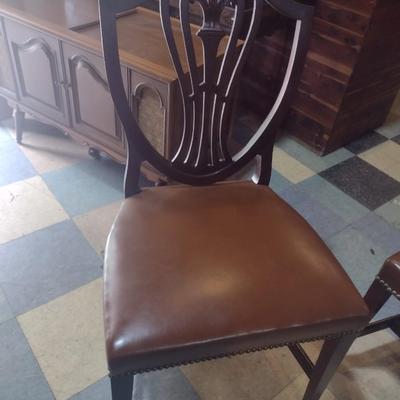 Set of four wood framed chairs with brass tack accents
