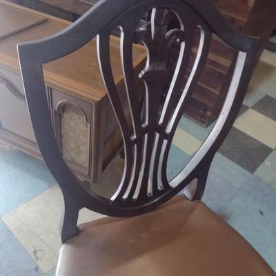 Set of four wood framed chairs with brass tack accents