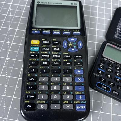 Texas Instrument TI 83 Graphic Calculator and Sharp Calculator
