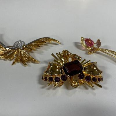 3 gold tone brooches with stones