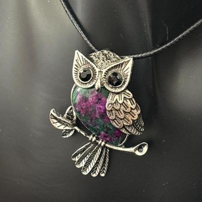 Silver tone owl with stone on ribbon material necklace