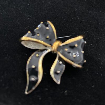 Gold toned and silver toned bow pin