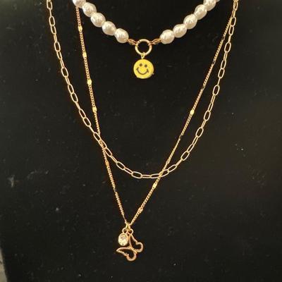 Multi layered, gold, toned, and pearl necklace with butterfly pendant
