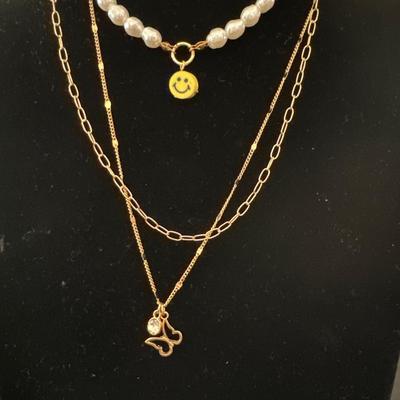 Multi layered, gold, toned, and pearl necklace with butterfly pendant