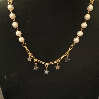 Super cute, gold, toned, pearl and black Dingle star necklace