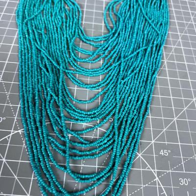 Turquoise Colored Tiny Beads and Lots of Strings