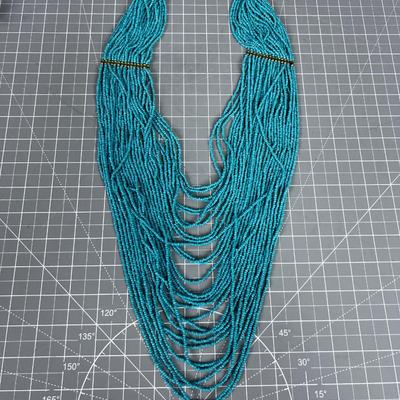 Turquoise Colored Tiny Beads and Lots of Strings