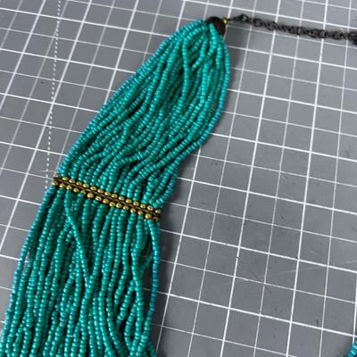 Turquoise Colored Tiny Beads and Lots of Strings