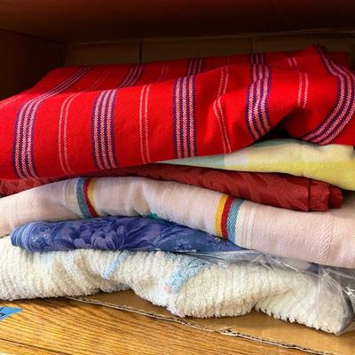 Wooden cabinet baskets full of antique quilts
