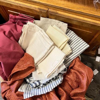 Wooden cabinet baskets full of antique quilts