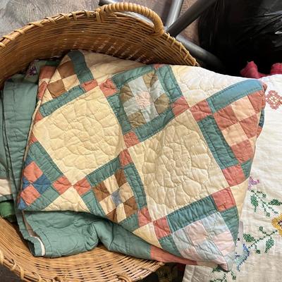 Wooden cabinet baskets full of antique quilts
