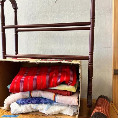 Wooden cabinet baskets full of antique quilts